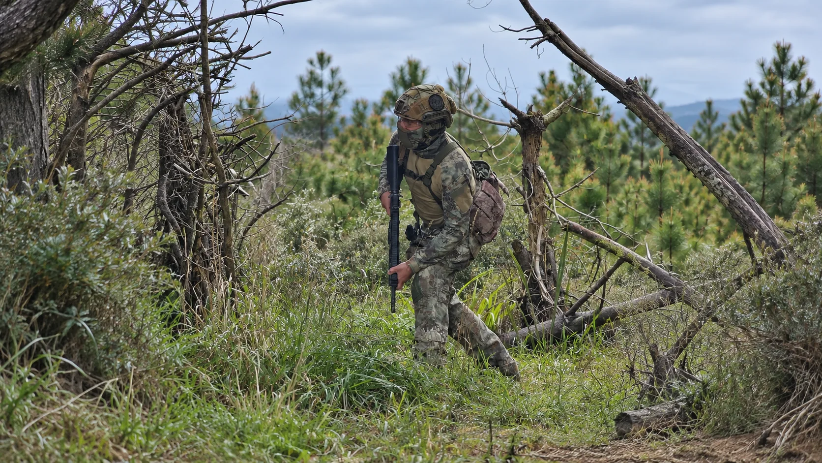 Airsoft player moving through thick vegetation